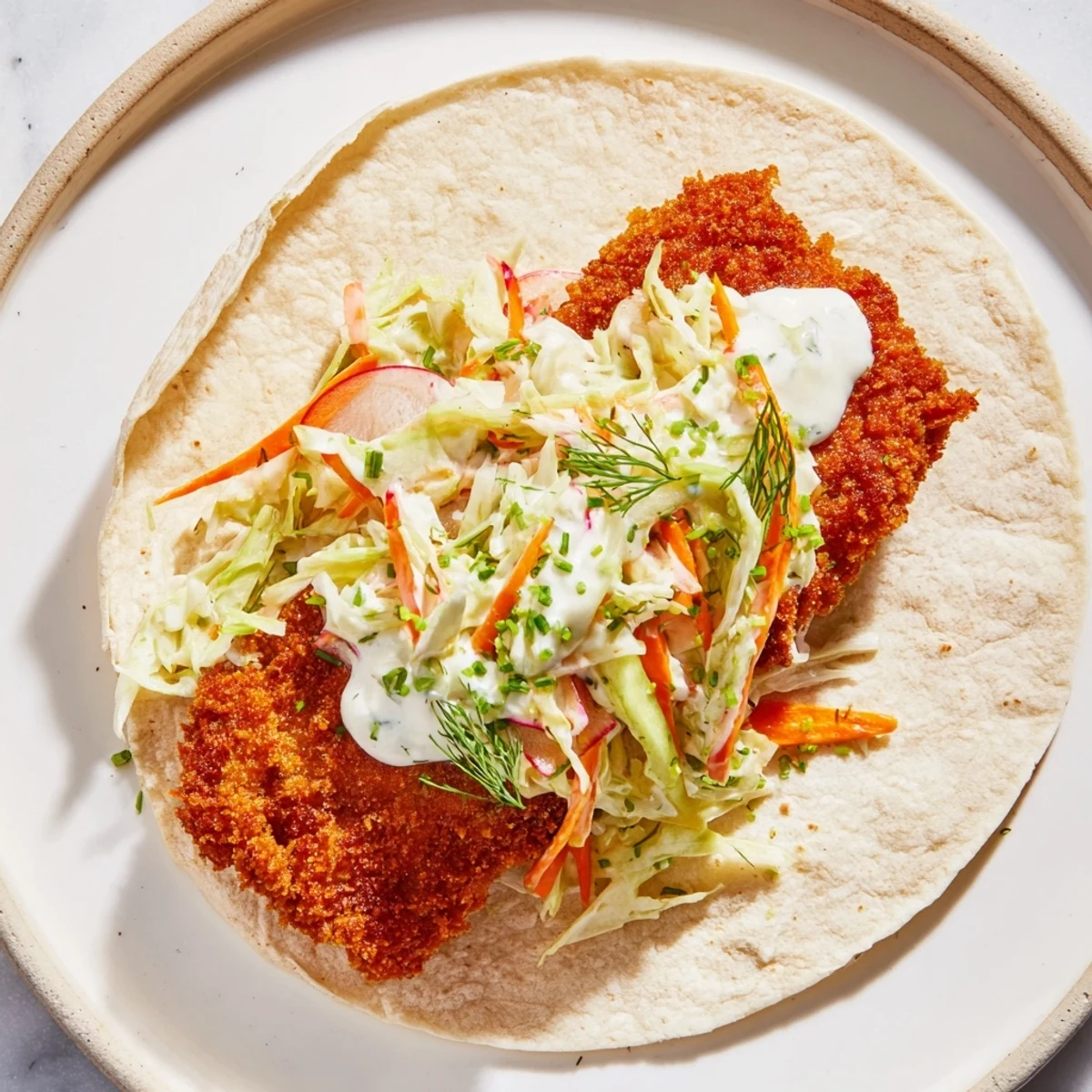 Golden-brown pork schnitzel tacos with a vibrant sauerkraut slaw, ready to be enjoyed.