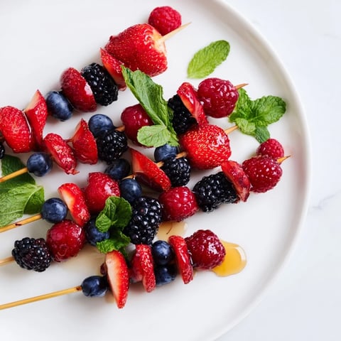 A colorful image of simple berry and mint skewers, a refreshing summer snack.