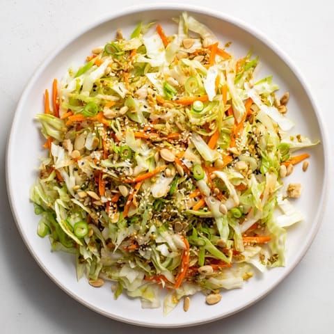 Freshly tossed Cabbage Core Slaw salad; a crunchy, Asian-inspired side dish with sesame dressing.